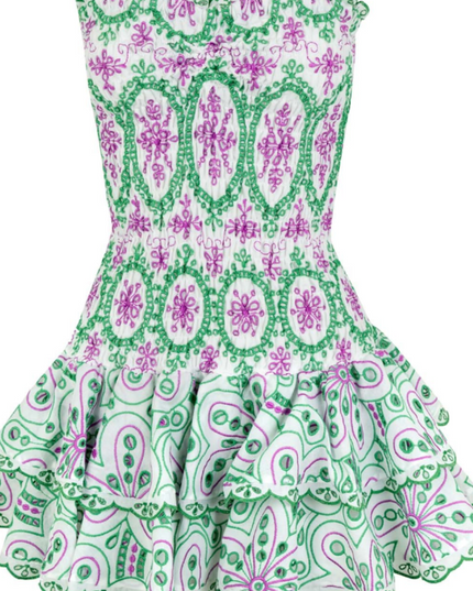 Flat lay front view of a white strapless mini dress with intricate green and purple embroidered patterns and tiered ruffles.