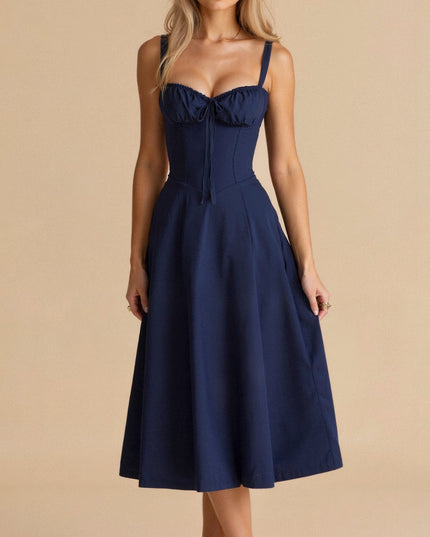 Front view of a navy blue summer midi dress with a structured corset bodice and delicate bow detail.