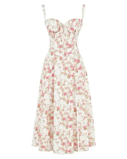 Flat lay of a white floral corset bow front midi dress adorned with vibrant pink rose patterns.