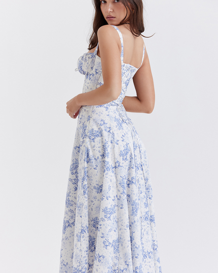Back view of women's white summer midi dress with blue floral print, showcasing the flowy skirt