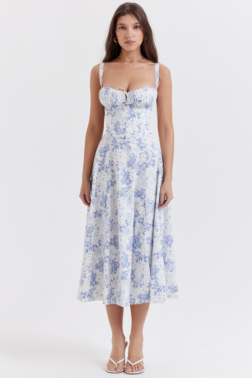 Full body shot of women's white midi dress with blue floral pattern, for summer occasions