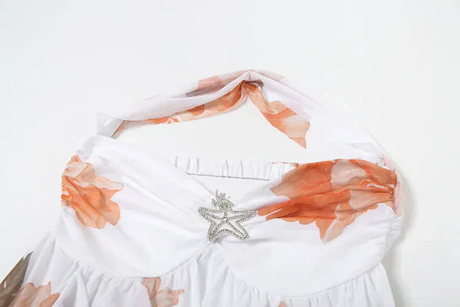 Top view of the white summer floral ruffle halter mini dress showing the halter neck tie and starfish embellishment.