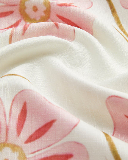 Detailed close-up of the white fabric with pink and gold floral print, highlighting the dress's pattern and material.