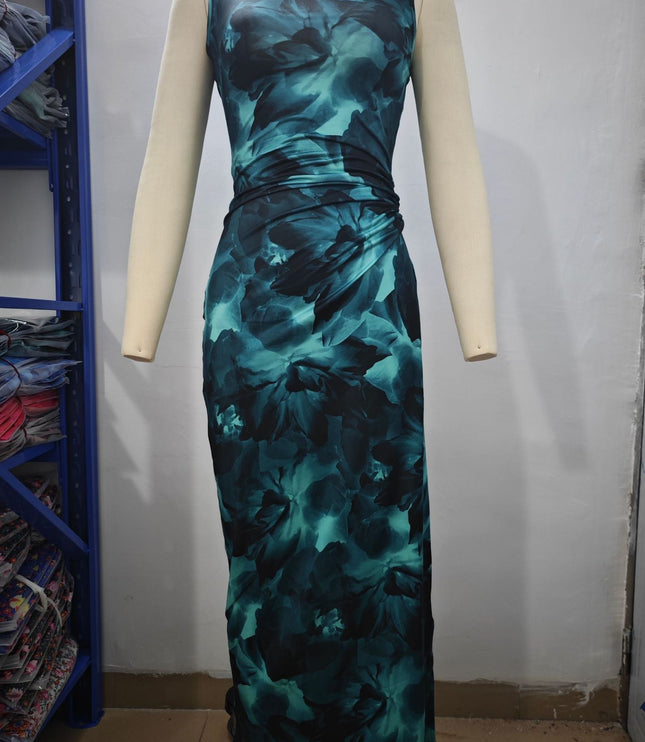 Back view of a women's sleeveless midi dress in a teal and black gradient floral print, with subtle ruching.