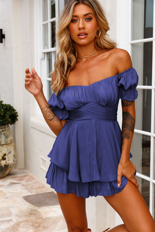 Full-length front view of a women's deep blue off-shoulder tiered ruffle romper, for summer outfits.