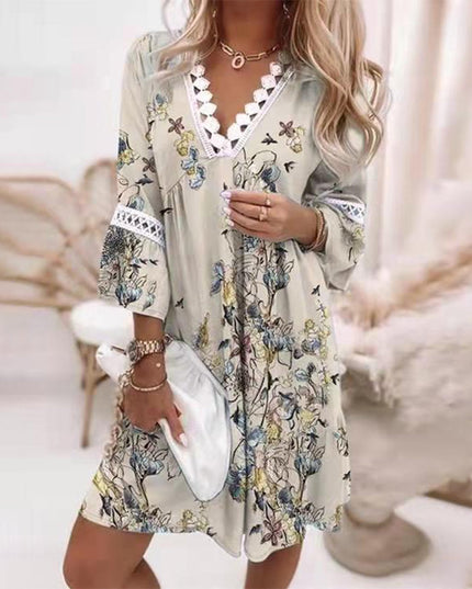 Women's summer mini dress in a light beige with delicate blue and yellow floral print, V-neck, and lace trim.