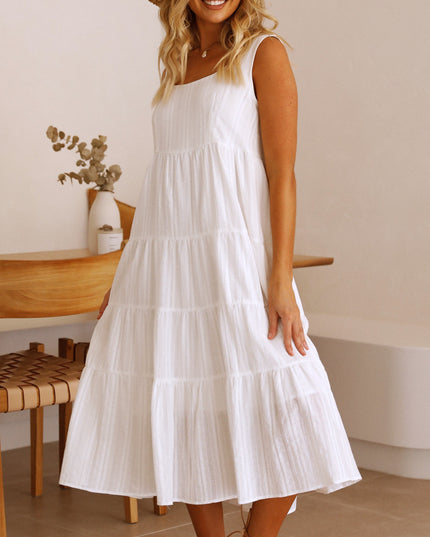 Elegant white square neck sleeveless tiered midi dress, for summer, shown in a relaxed indoor setting.