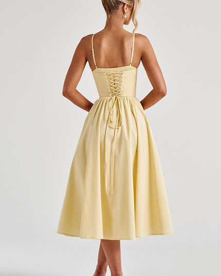 Back view of a light yellow sweetheart corset midi dress showing the lace-up detail and full skirt.