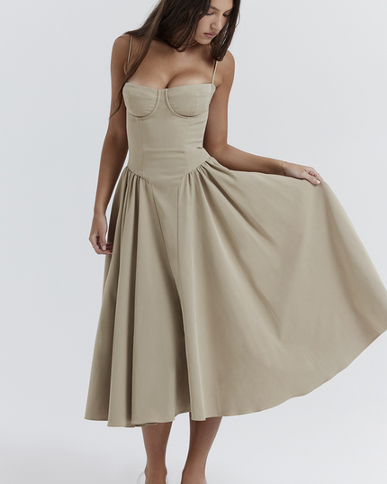 Side view of a women's light khaki sweetheart neck corset midi dress, showing the flowing skirt and structured bodice.