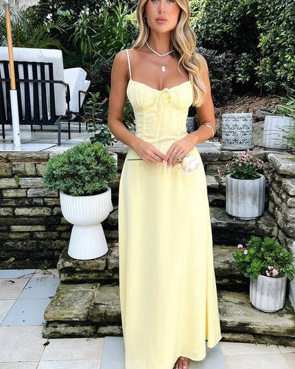 Elegant yellow summer maxi dress for women, featuring a tie-front bust, structured bodice, and a long, flowing skirt.