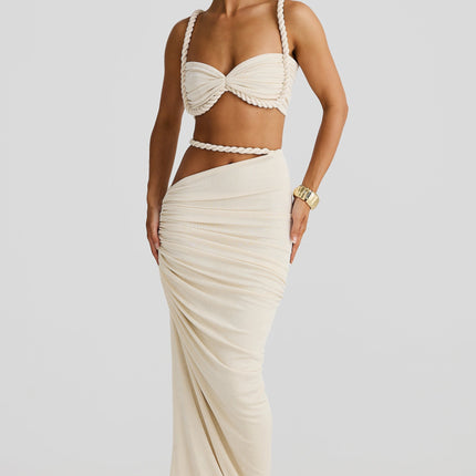 Women's summer two-piece rope maxi skirt set in an off-white color, featuring a twisted rope bandeau top and a draped, fitted maxi skirt.