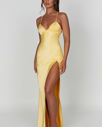 Angled front view of the yellow satin maxi dress, emphasizing the V-neckline and the elegant side slit.