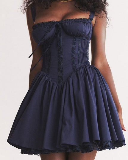 Close-up of the navy sweetheart neck mini dress, highlighting the gathered bust, corset stitching, and lace trim.