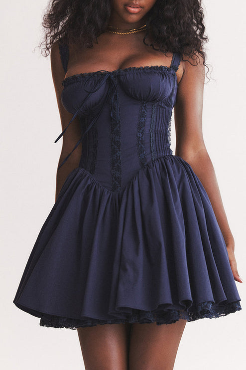 Close-up of the navy sweetheart neck mini dress, highlighting the gathered bust, corset stitching, and lace trim.