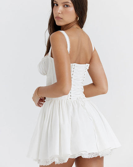 Back view of the white sweetheart neck mini dress, featuring a classic lace-up corset closure and ruffled straps.
