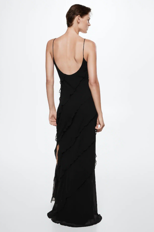 Back view of a black V-neck ruffle side slit maxi dress with a low back and flowing ruffles