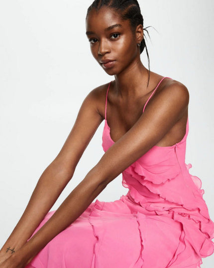 Seated view of the women's pink V-neck ruffle maxi dress, showcasing the flowing fabric and ruffles.
