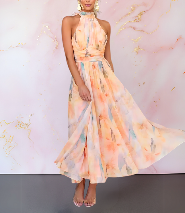 Flowing women's watercolor halter maxi dress in peach and blue, showcasing the movement of the open back design.