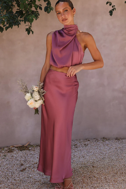 Front view of a women's plum satin two-piece maxi set, featuring a draped high neck crop top and long skirt.