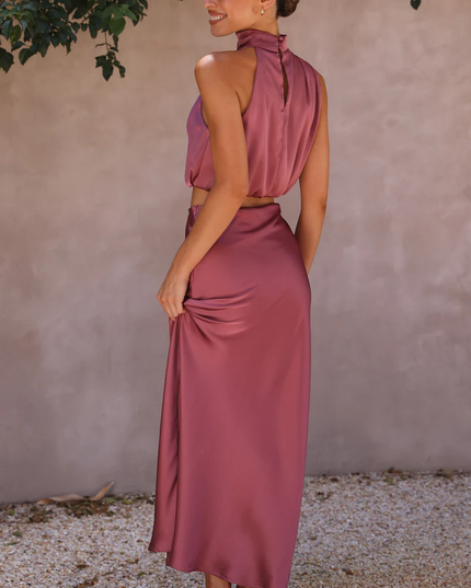 Back view of the plum satin two-piece maxi set, showing the high neck top with button closure and long skirt.