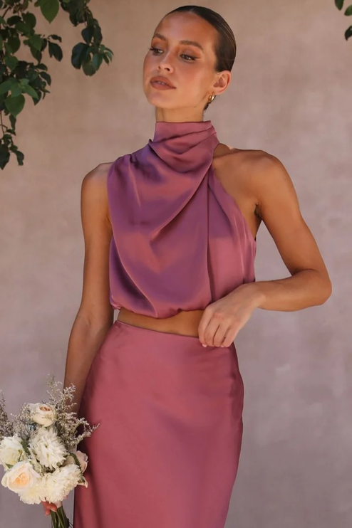 Close-up of the plum satin asymmetrical high neck crop top, part of a wedding guest maxi set.
