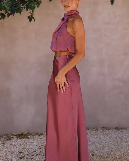 Side profile of a woman wearing the plum satin two-piece maxi set, highlighting the elegant silhouette.