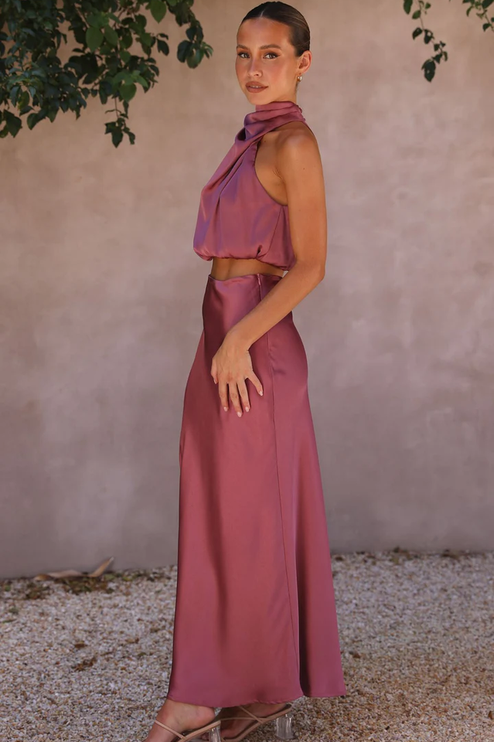 Side profile of a woman wearing the plum satin two-piece maxi set, highlighting the elegant silhouette.