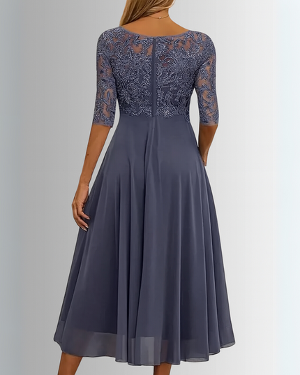 Back view of a women's dark grey boat neck midi dress, showing the elegant lace pattern on the bodice and sheer sleeves, with a smooth, flowing chiffon skirt.