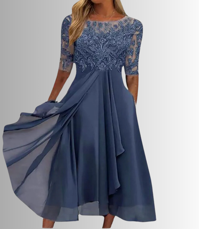 Women's slate blue boat neck midi dress with intricate lace bodice, sheer elbow-length sleeves, and flowing chiffon skirt with pockets, for wedding guests.