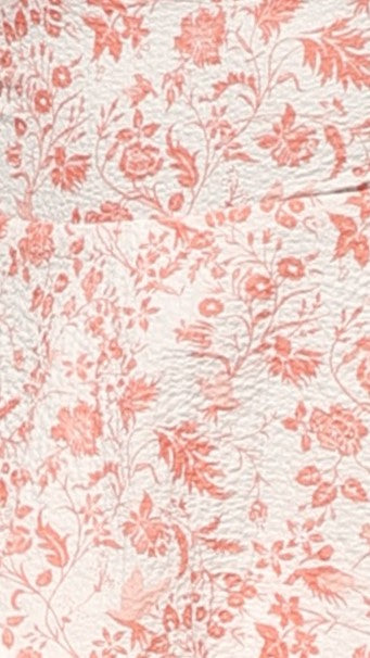 Close-up of the white and pink floral pattern on the ruffled maxi dress, showing intricate details.