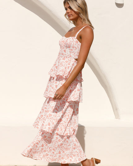 Side profile of a woman wearing the pink floral ruffled maxi dress, showing movement and flow of the tiered skirt.