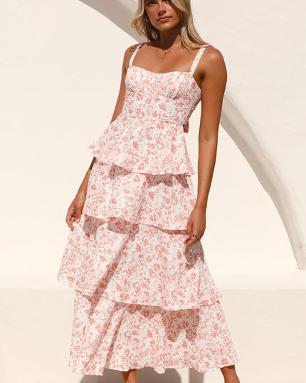 Front view of a woman wearing the pink floral ruffled maxi dress, showcasing the full length and tiered design.