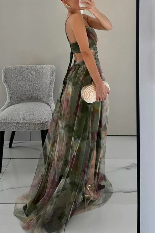 Side view of a women's green floral V-neck sleeveless maxi dress, showing the flowing skirt and back strap details.