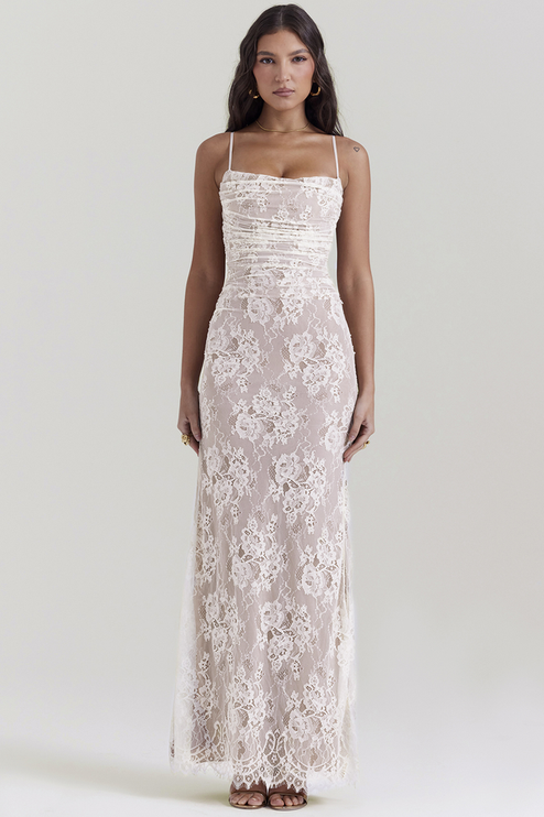 Front view of white lace corset back strapless maxi dress, showing spaghetti straps and ruched bust detail.