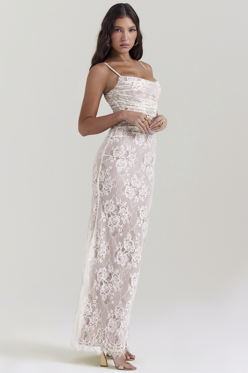 Side profile of white lace corset back strapless maxi dress, highlighting the fitted silhouette and subtle train.