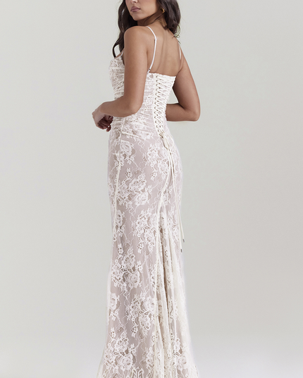 Back view of white lace maxi dress, showcasing the intricate corset lacing detail and flowing skirt.