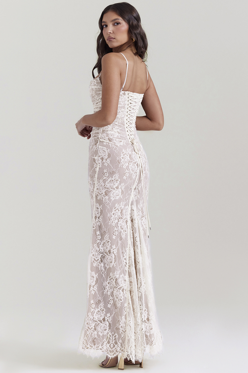 Back view of white lace maxi dress, showcasing the intricate corset lacing detail and flowing skirt.