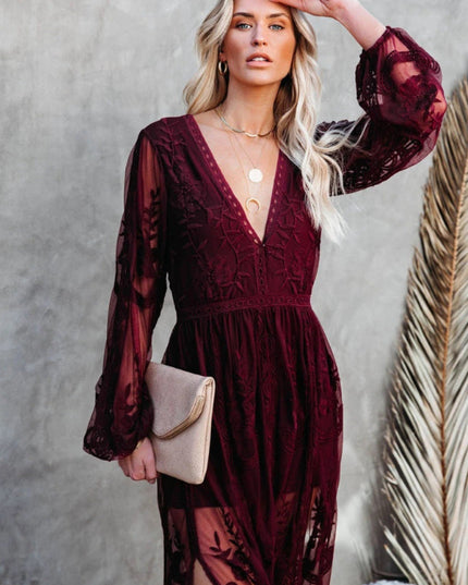Close-up of a women's deep burgundy lace long sleeve V-neck maxi dress, highlighting the intricate lace pattern.