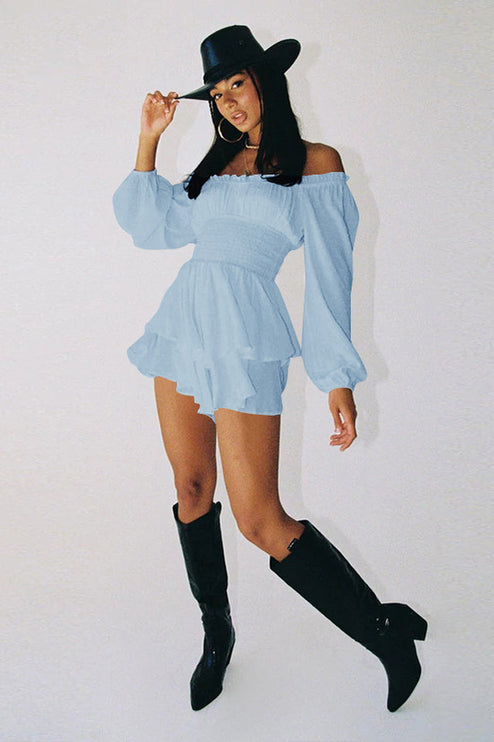 Full body shot of light blue off-shoulder mini dress with long sleeves and black boots