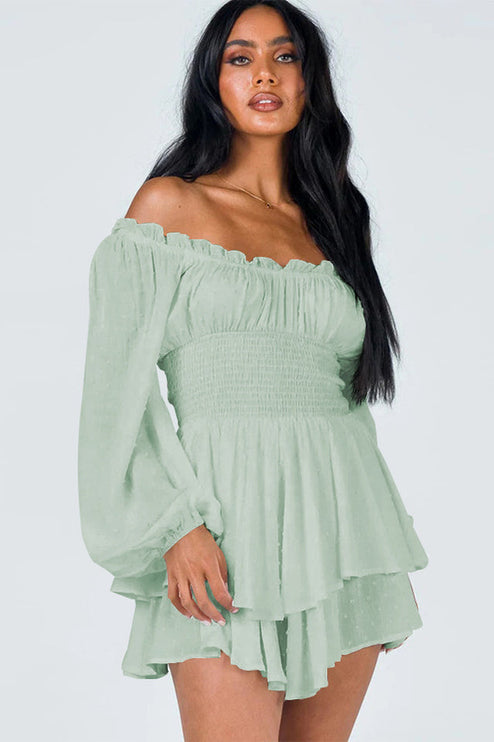 Close-up of a women's light green off-shoulder mini dress with ruched bodice and long balloon sleeves.