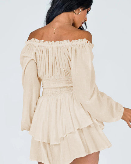 Back view of a women's off-shoulder mini dress in a light peach color with long sleeves and ruffled skirt