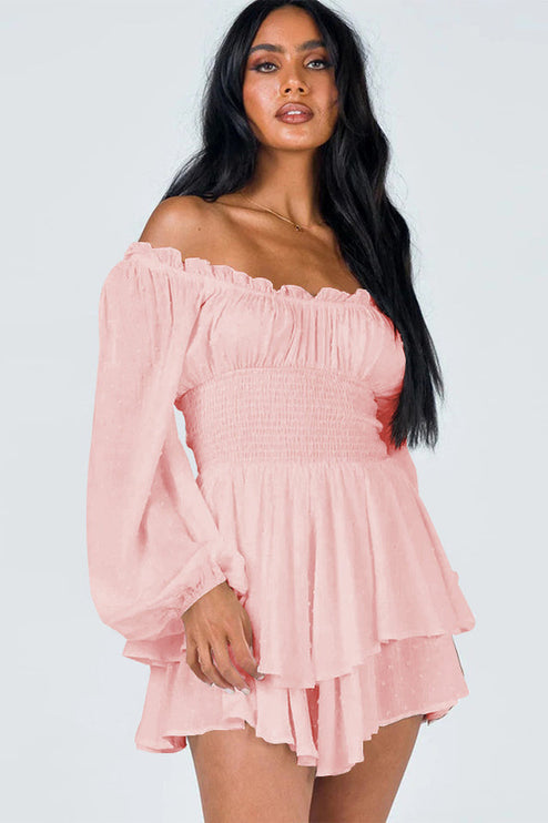 Close-up front view of a women's light pink off-shoulder mini dress with long sleeves, shirred bodice, and ruffled hem