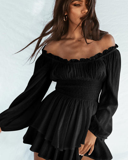 Black off-shoulder long sleeve mini dress with smocked waist and tiered ruffled skirt, featuring subtle textured dots.