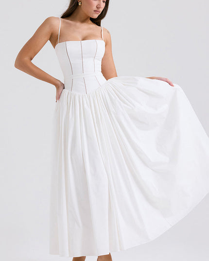 Full view of women's white sleeveless midi dress, featuring a square neckline and flowing pleated skirt, with green heels.
