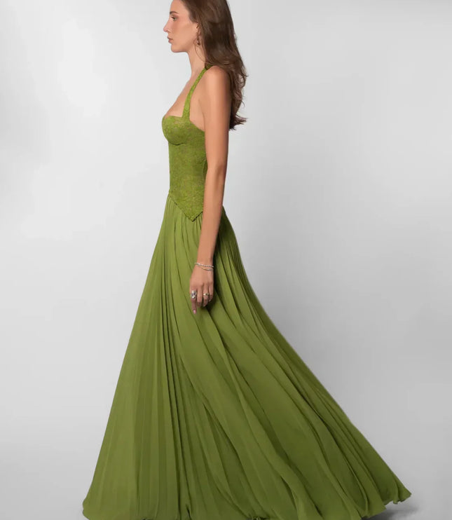 Side profile olive green halter lace maxi dress with structured bodice and sweeping pleated hem