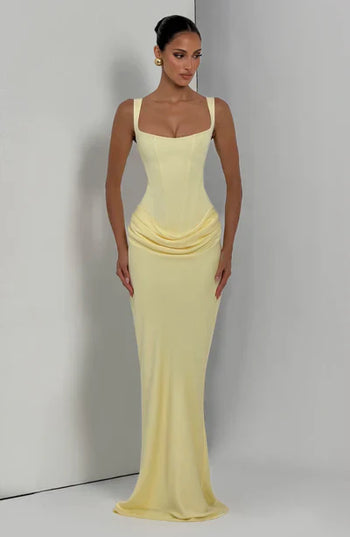 Pale yellow square neck corset maxi dress with fit and flowing hem, angled front view