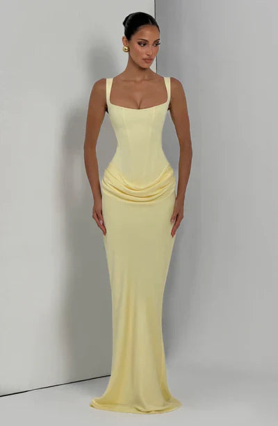 Pale yellow square neck corset maxi dress with fit and flowing hem, angled front view
