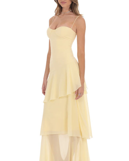 Side view pale yellow corset ruffled maxi dress with layered chiffon skirt and fitted waist