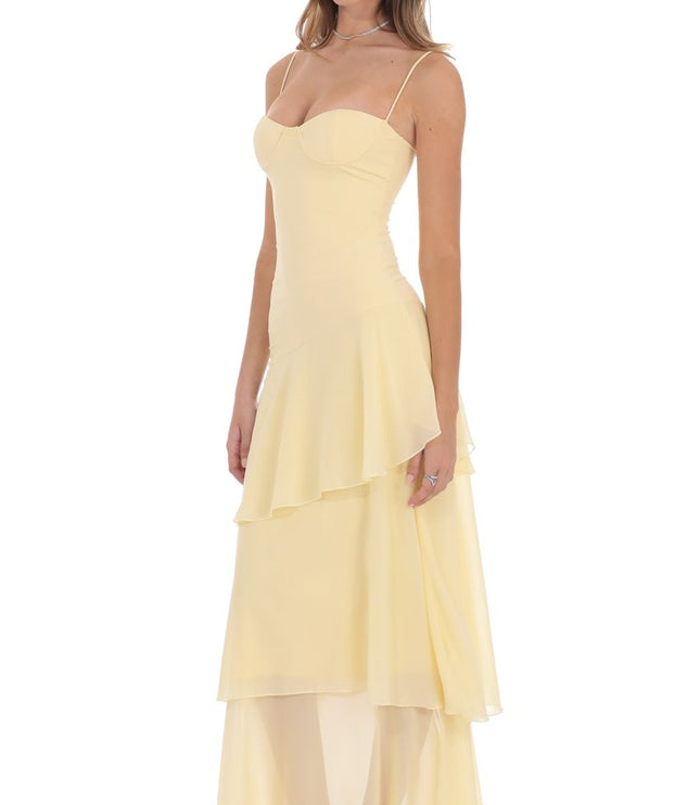 Side view pale yellow corset ruffled maxi dress with layered chiffon skirt and fitted waist