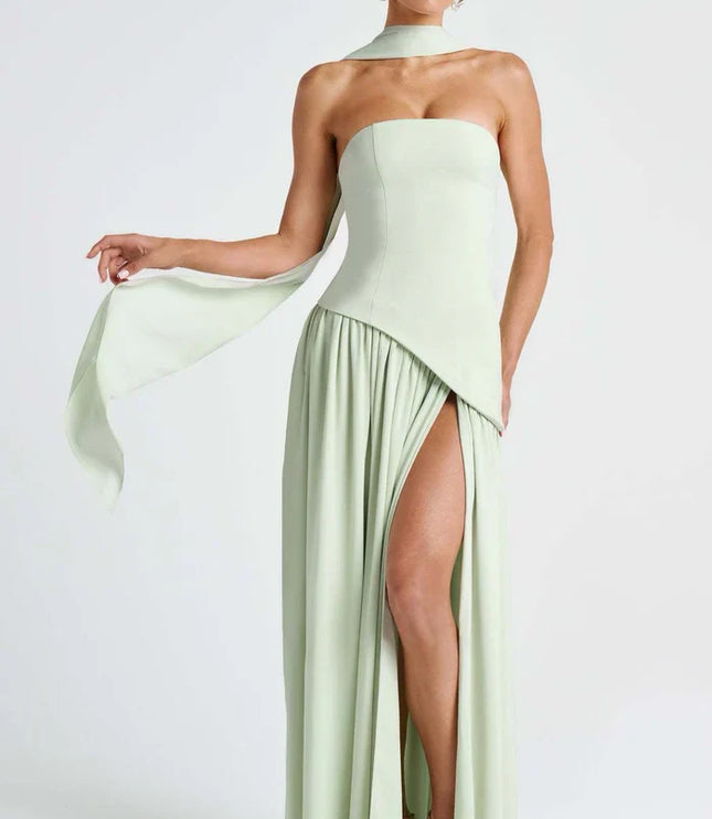 Pale yellow halter maxi dress from the back with ruched lace-up bodice and long draped panels